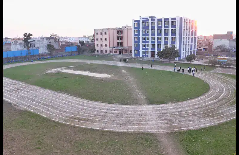 Students walking near running track and academic buildings at IITM Murthal campus